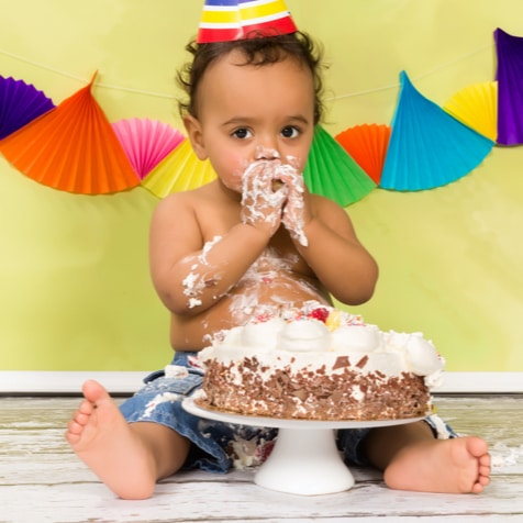 Kid messily eating a cake